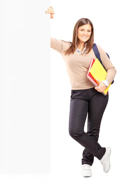 Female student next to billboard — Stock Photo, Image