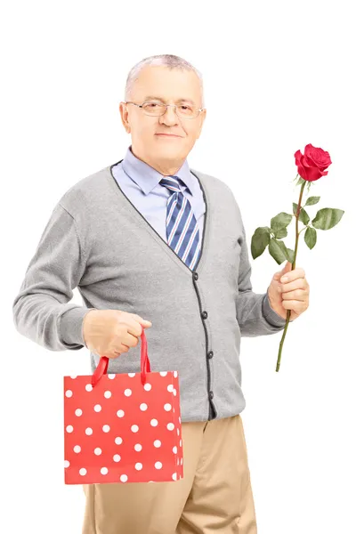 Gentleman holding rose and bag — Stock Photo, Image