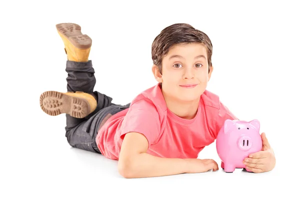 Pojke anläggning piggybank — Stockfoto