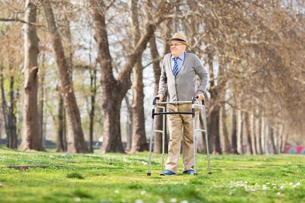 Senior gentleman with walker in park — Stock Photo, Image