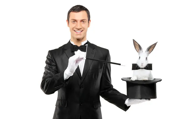 Magician holding hat with rabbit — Stock Photo, Image