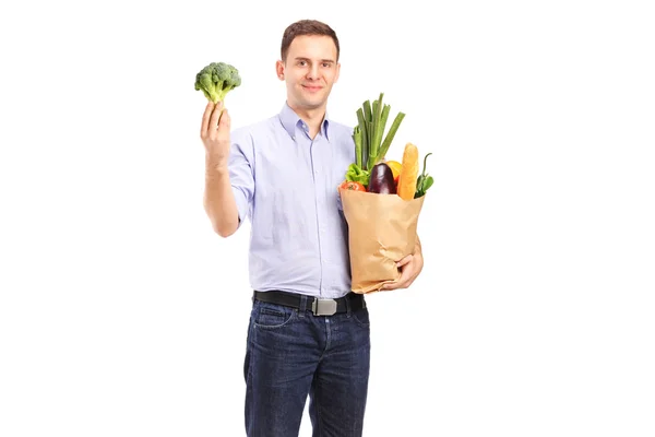 Man holding shopping bag with products — Stock Photo, Image