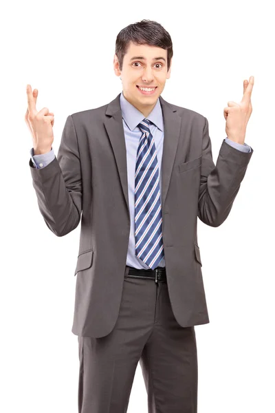 Businessman with fingers crossed for luck — Stock Photo, Image