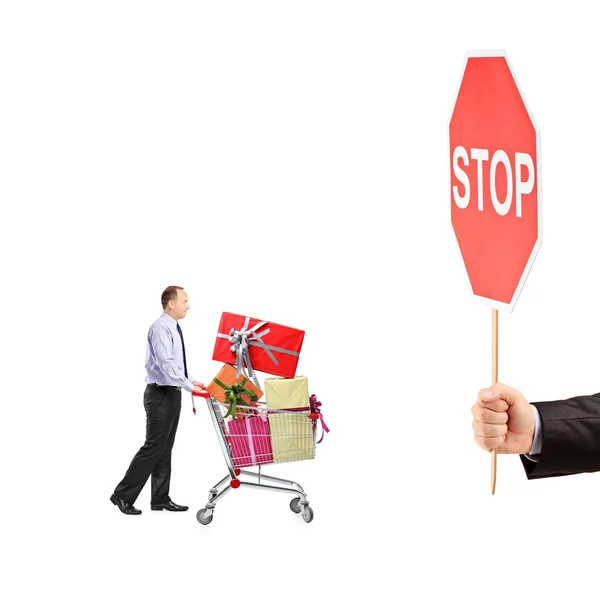 Man pushing shopping cart with gifts — Stock Photo, Image