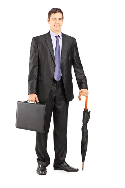 Uomo d'affari con ombrello e valigetta — Foto Stock