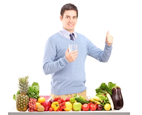 Man standing next to pile of food — Stock Photo, Image