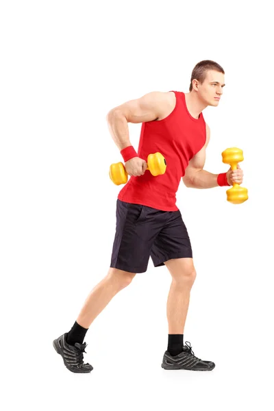 Muscular athletic man lifting dumbbell Stock Photo