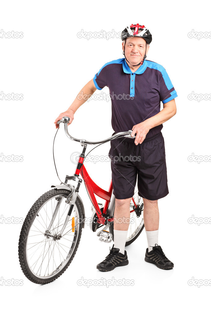 Senior bicyclist next to bicycle