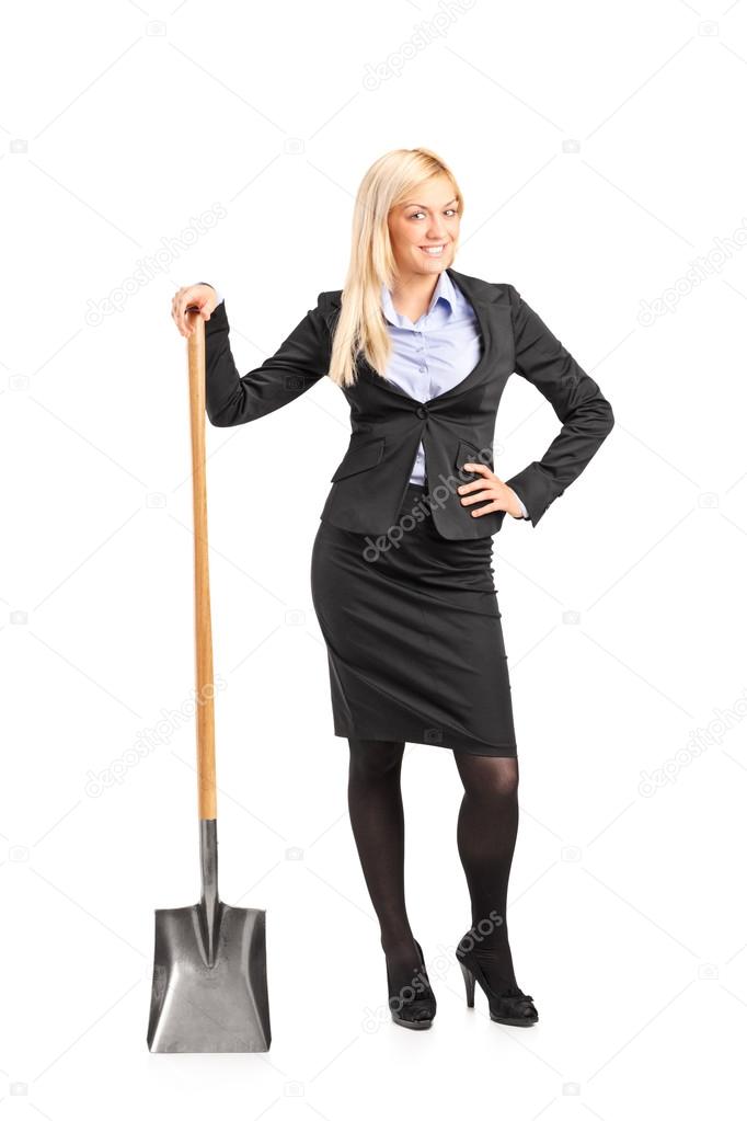 Businesswoman holding shovel