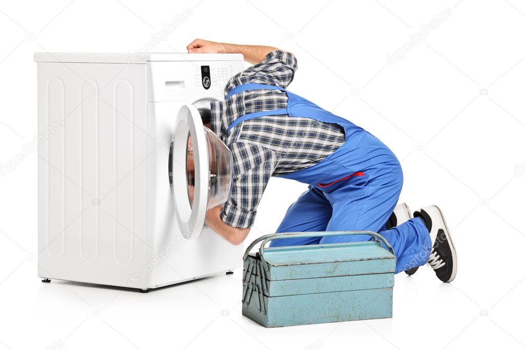 Repairman fixing washing machine