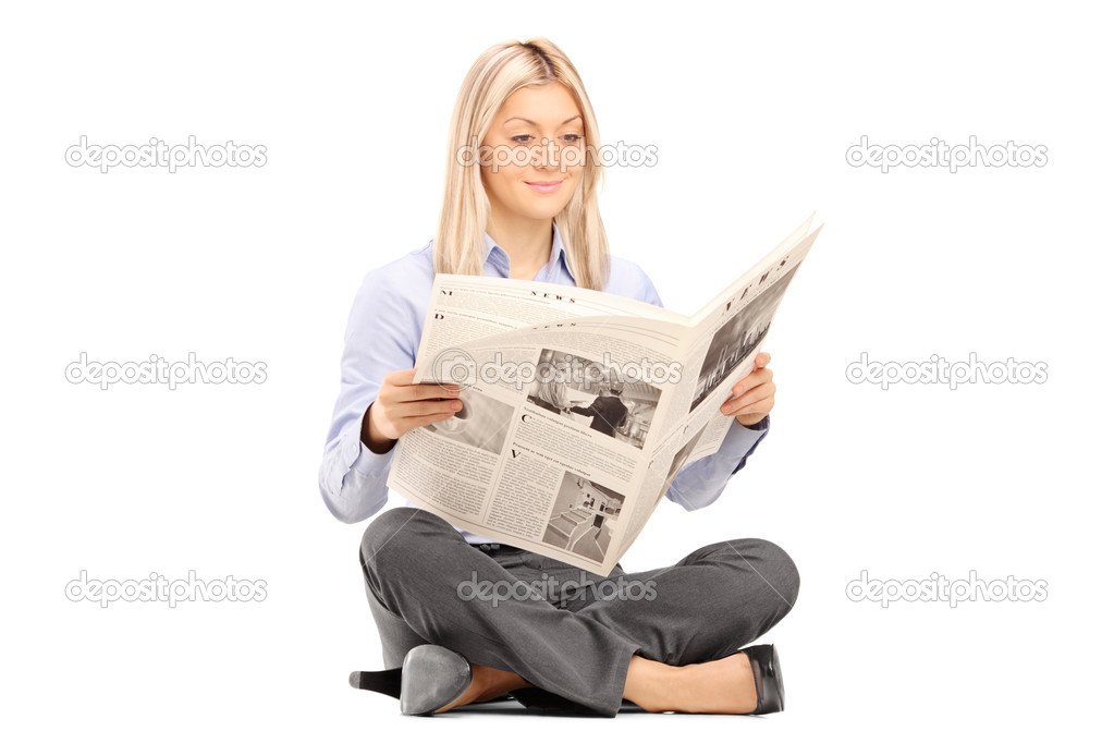 Woman on floor reading a newspaper