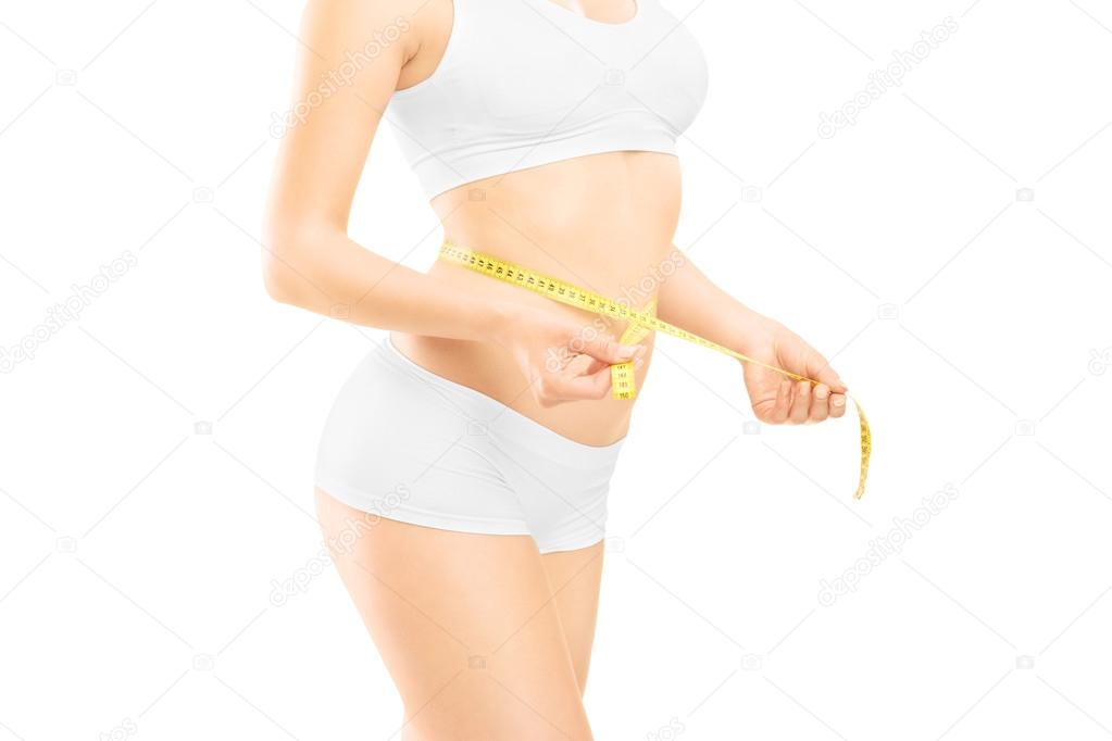 Woman measuring waist after diet