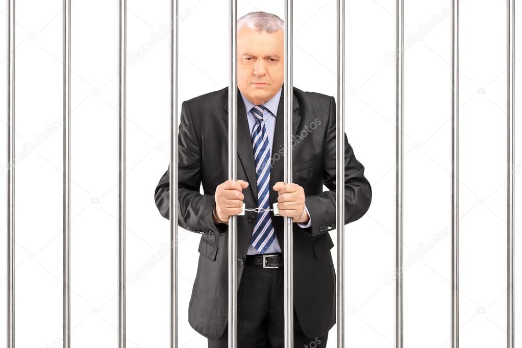 Manager in jail holding bars