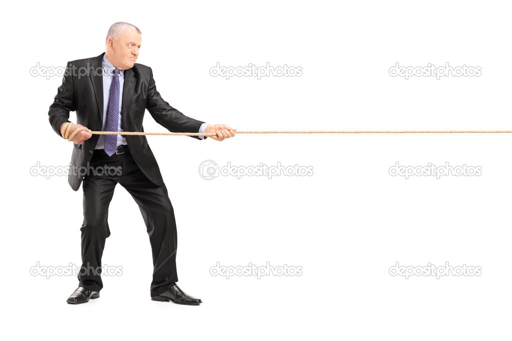 Mature businessman pulling rope