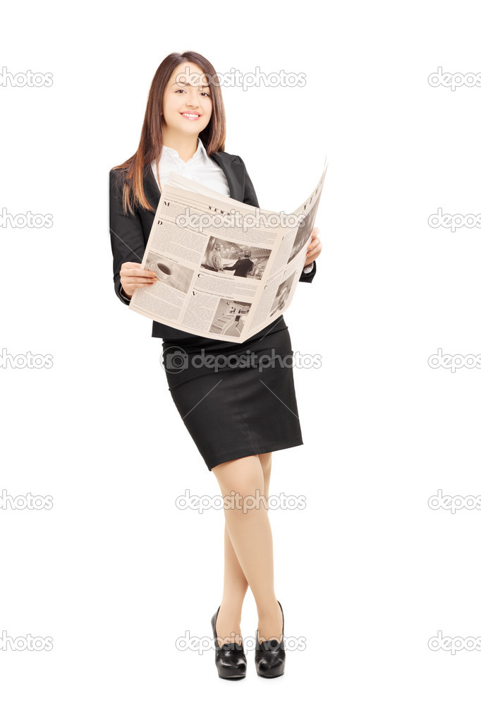 Young businesswoman holding newspaper