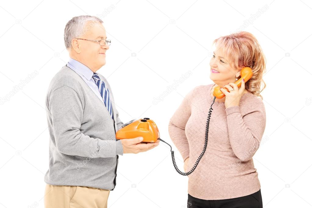 Couple using old telephone