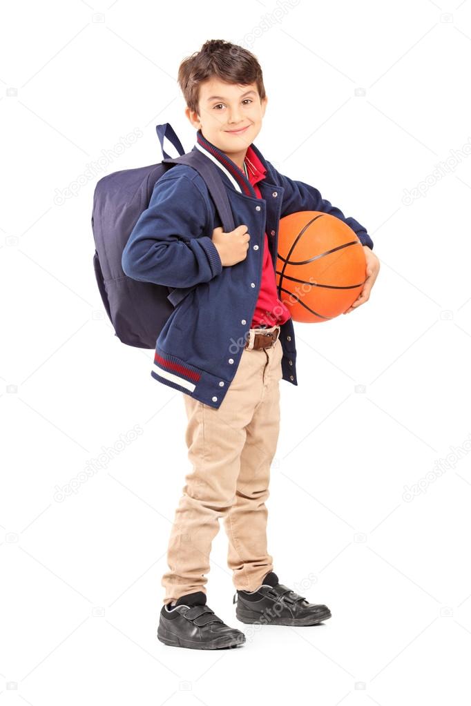 Schoolboy with backpack holding basketball