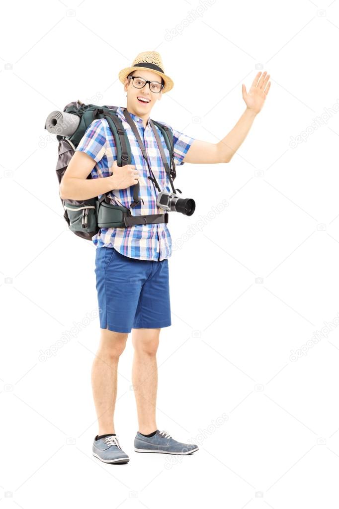 Male tourist waving with his hand
