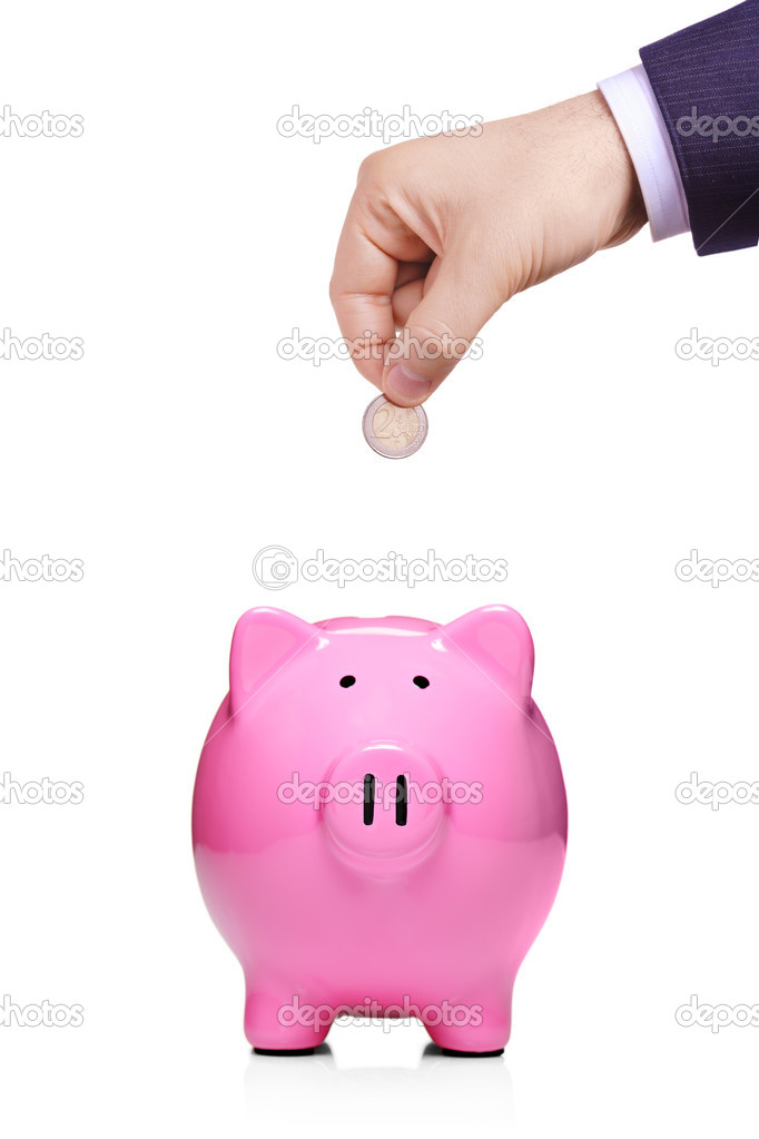 Hand inserting coin into piggybank
