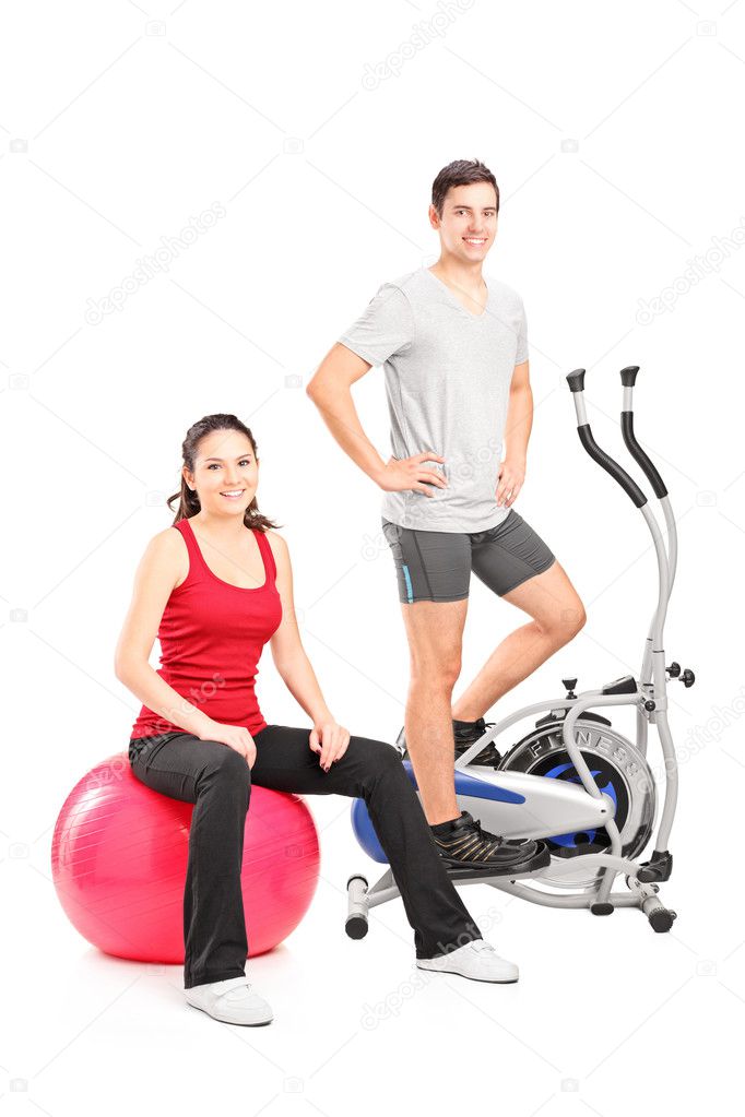 Couple posing with fitness equipment
