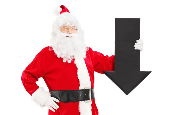 Santa Claus holding black arrow — Stock Photo, Image