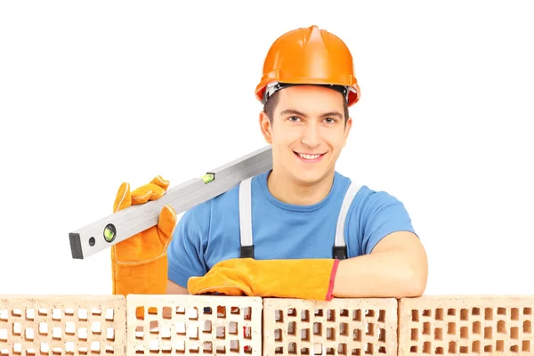 Male construction holding bubble level — Stock Photo, Image