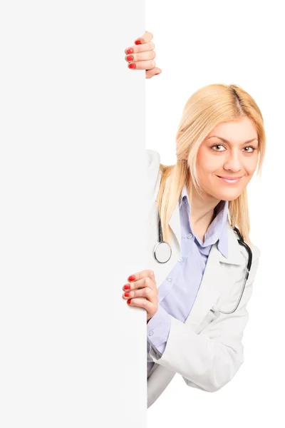 Medical doctor posing on blank panel — Stock Photo, Image