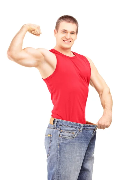 Weight loss man in an old jeans — Stock Photo, Image