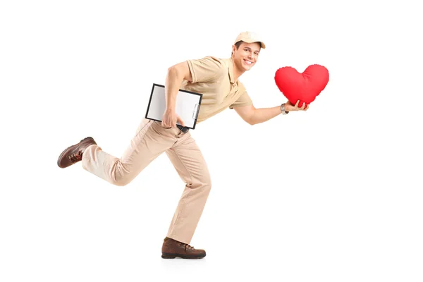 Delivery boy delivering red heart — Stock Photo, Image