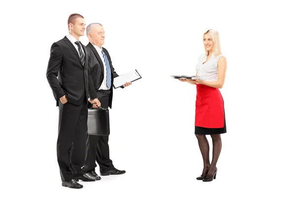 Blond waitress serving businessmen — Stock Photo, Image