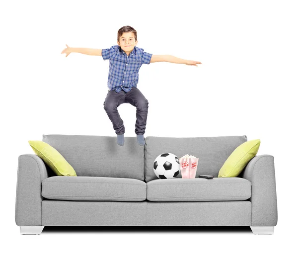 Little boy jumping on sofa — Stock Photo, Image