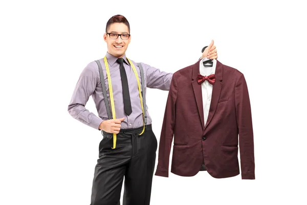 Fashion designer holding suit — Stock Photo, Image