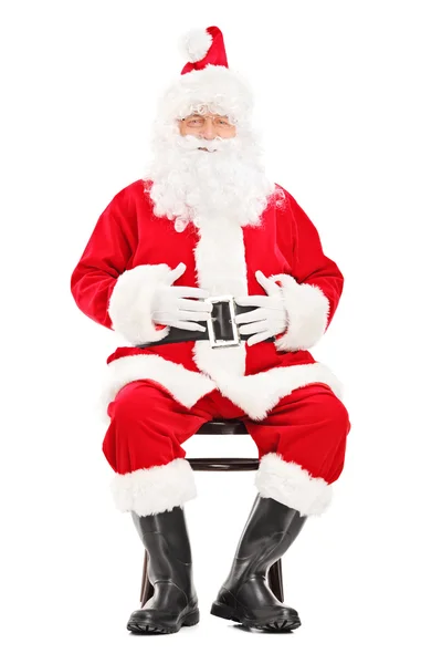 Santa claus sitting on wooden chair — Stock Photo, Image