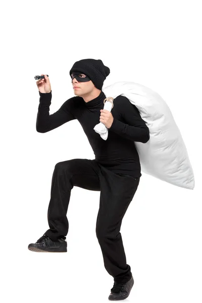 Robber with bag and flashlight — Stock Photo, Image