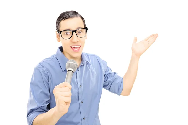 Young male singing on microphone — Stock Photo, Image