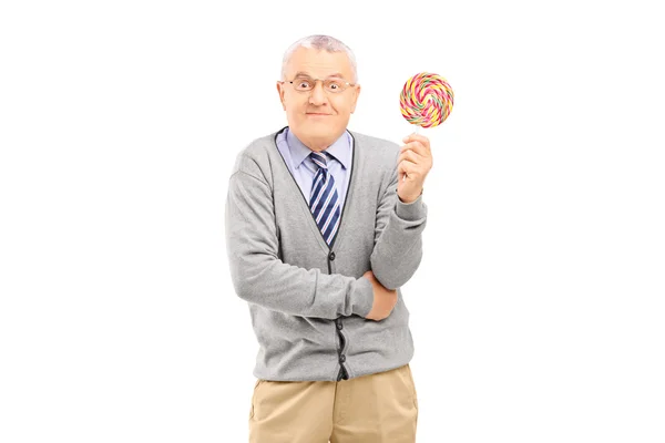 Mature man holding lollipop — Stock Photo, Image