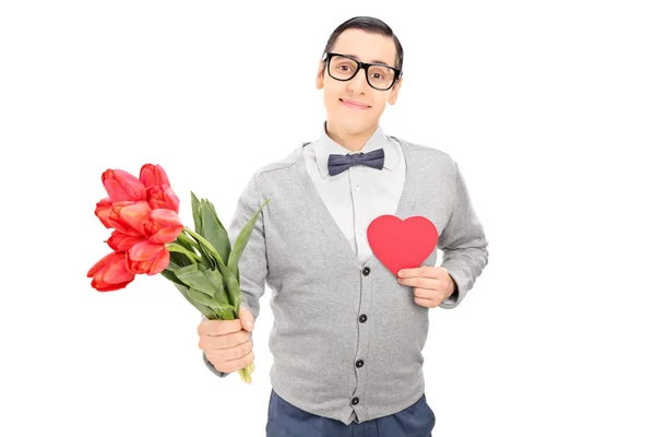 Cara segurando coração e flores — Fotografia de Stock