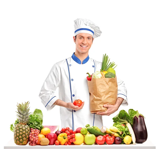Chef holding tomato and bag — Stock Photo, Image