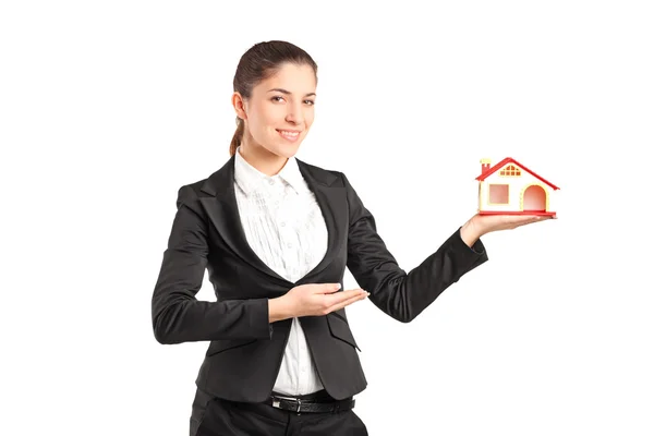 Businesswoman holding a small toy house — Stock Photo, Image