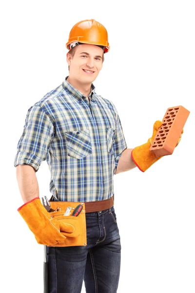 Male construction holding brick — Stock Photo, Image