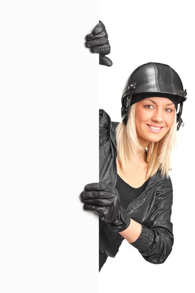 Female motorcyclist holding blank panel — Stock Photo, Image