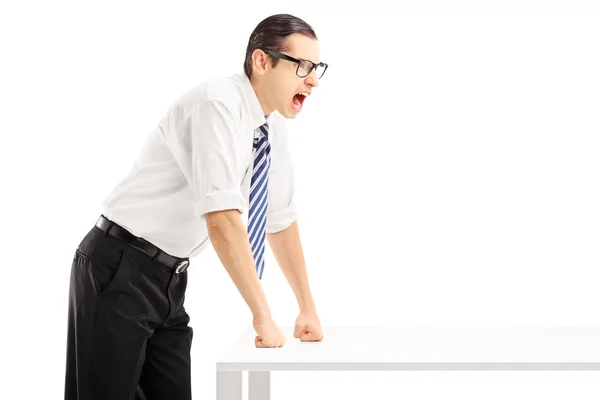 Young angry man on a table yelling — Stock Photo, Image