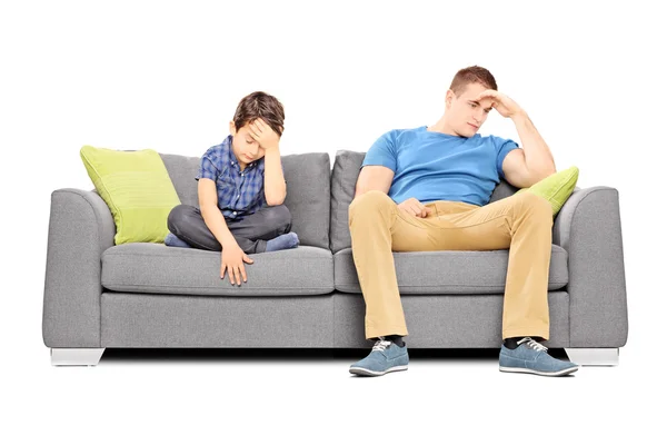 Dissappointed brothers on sofa — Stock Photo, Image