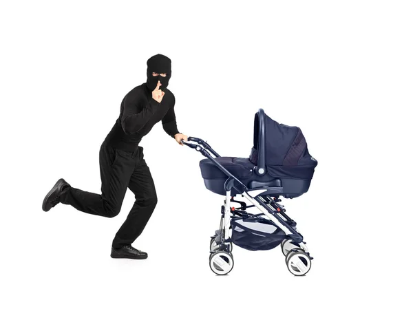 Robber running and pushing a baby stroller — Stock Photo, Image