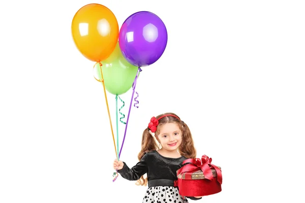 Girl holding gift and balloons — Stock Photo, Image