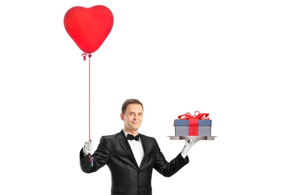 Waiter holding balloon and gift — Stock Photo, Image