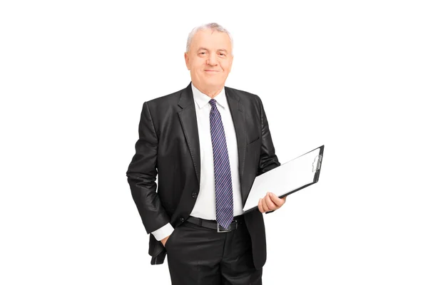 Mature businessman holding clipboard — Stock Photo, Image