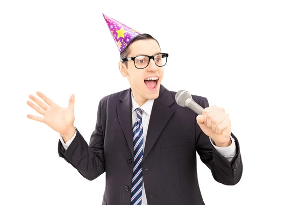 Young man with party hat singing — Stock Photo, Image