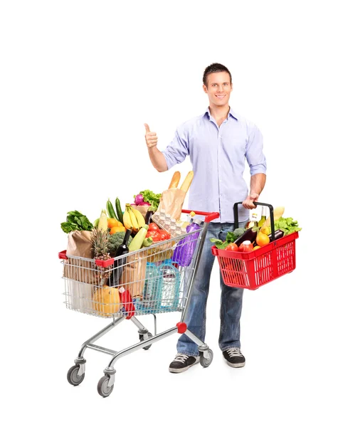 Man holding shopping basket and cart — Stock Photo, Image