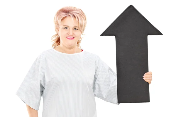 Hospital gown holding big arrow — Stock Photo, Image